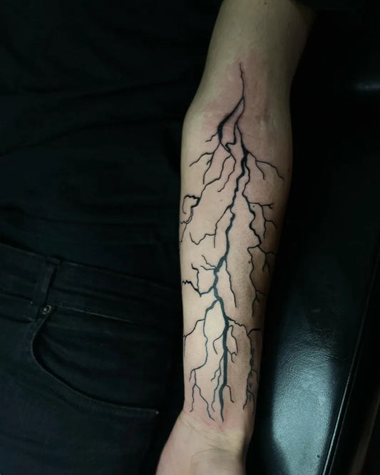 Medium Blackwork Lightning Tattoo on Men Arm by @splash.ink.tattoo