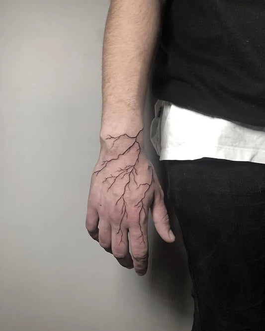 Medium Blackwork Lightning Tattoo on Men Hand by @tattoerr.arif