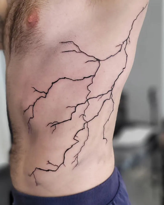 Medium Blackwork Lightning Tattoo on Men Rib by @jonnylwinter