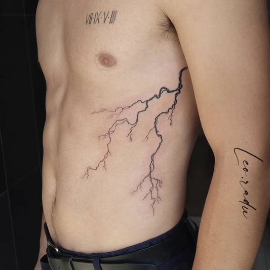 Medium Blackwork Lightning Tattoo on Men Ribs by @leoradu_tatoueurnice