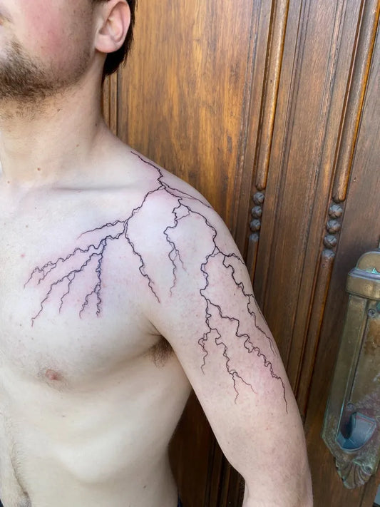 Medium Blackwork Lightning Tattoo on Men Shoulder by @alchemy.ink.nz
