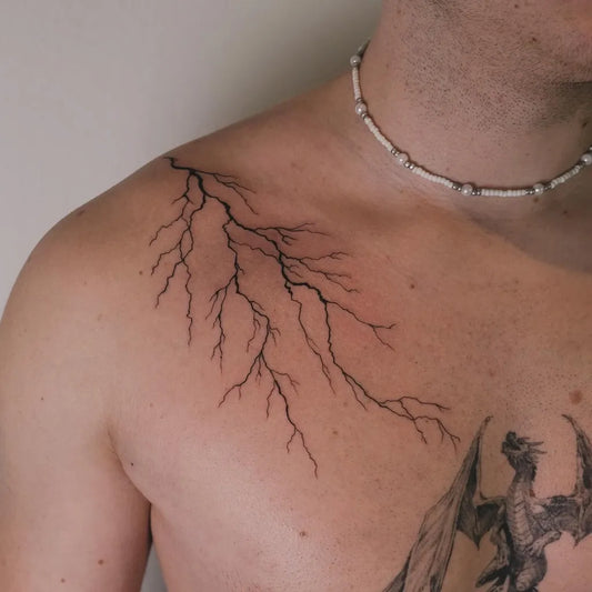 Medium Blackwork Lightning Tattoo on Men Shoulder by @inking.housewife
