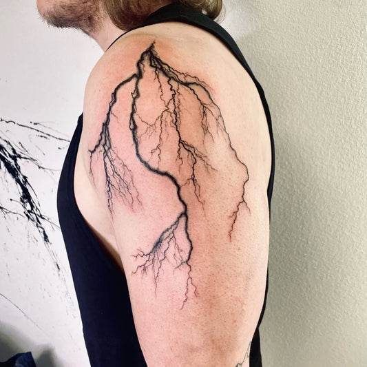 Medium Blackwork Lightning Tattoo on Men Shoulder by @supine_tattoo_and_art