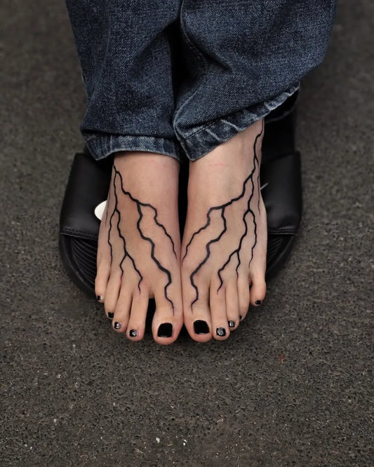 Medium Blackwork Lightning Tattoo on Women Feet by @sailorstattoomilanoduomo