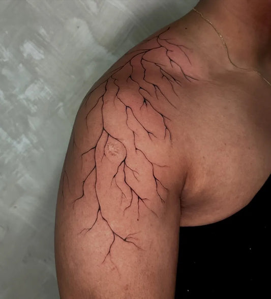 Medium Blackwork Lightning Tattoo on Women Shoulder by @nomadtattoostudioph