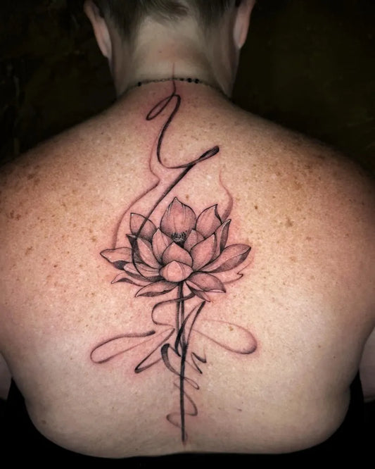 Medium Blackwork Lotus Flower with Swirls on Women Back Tattoo by @_akatana_