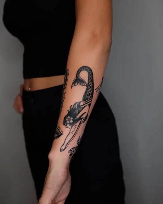 Medium Blackwork Mermaid Tattoo on Women Arm by @figtree.tattoo.studio