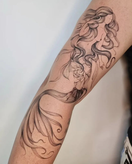 Medium Blackwork Mermaid Tattoo on Women Arm by @karoldiastattooist