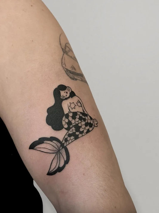 Medium Blackwork Mermaid Tattoo on Women Arm by @matilde.tattoo