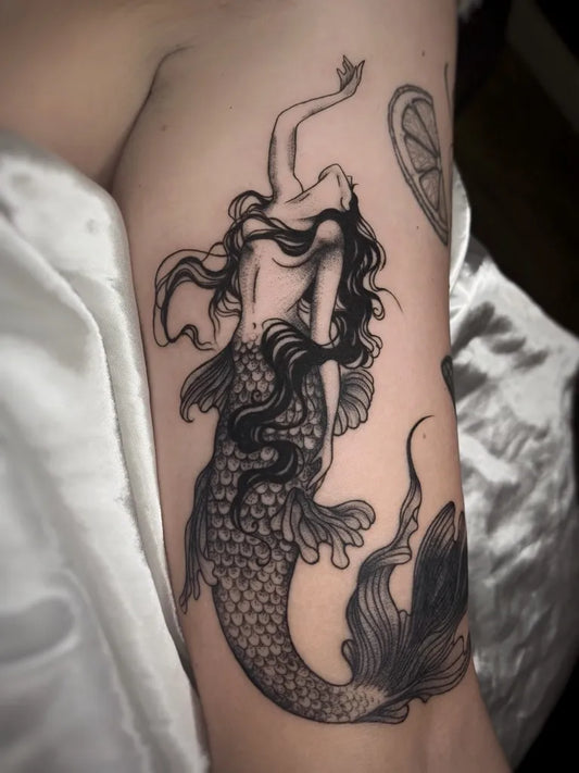Medium Blackwork Mermaid Tattoo on Women Arm by @sugar.tattoos