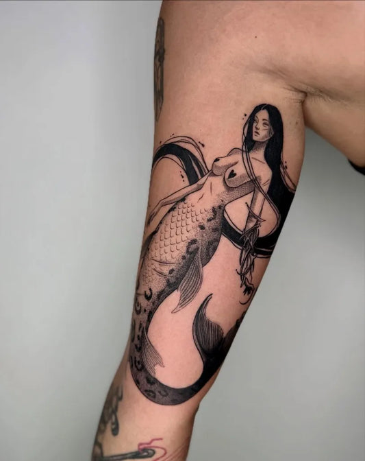Medium Blackwork Mermaid Tattoo on Women Arm by @threedots.tattoos