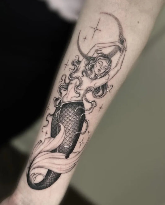 Medium Blackwork Mermaid and Crescent Moon Tattoo on Women Arm by @vil_tattoo