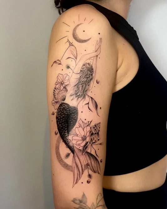 Medium Blackwork Mermaid and Flowers Tattoo on Women Shoulder by @tattoo_art_elisa