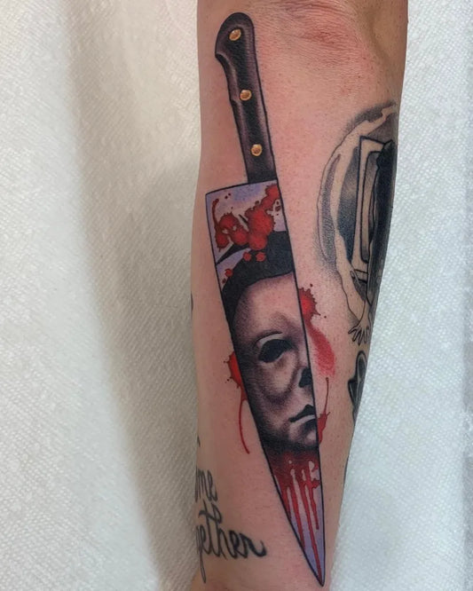 Medium Blackwork Michael Myers Mask and Knife Horror Tattoo on Men Arm by @tattoosbypony
