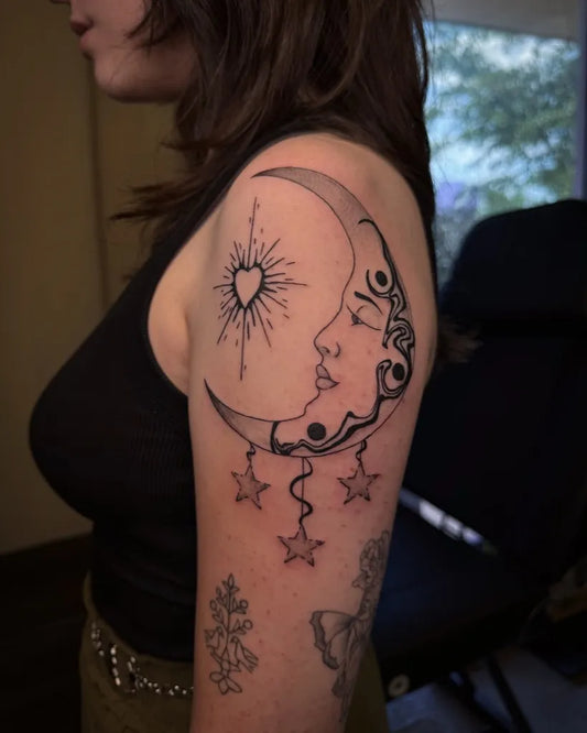 Medium Blackwork Moon Face Stars Tattoo on Women Shoulder by @kianahopetattoo