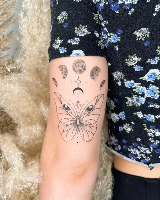 Medium Blackwork Moon Phases Butterfly Tattoo on Women Arm by @ladnie.ink