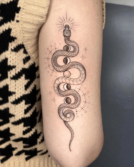 Medium Blackwork Moon Phases Snake Tattoo on Women Arm by @gayagatto