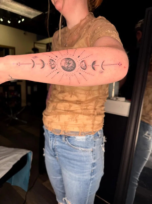Medium Blackwork Moon Phases Sun and Lines Tattoo on Women Arm by @burnedheartstattoos