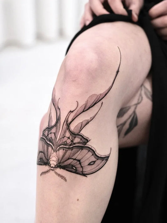 Medium Blackwork Moth Tattoo on Women Knee by @delicz.ttt