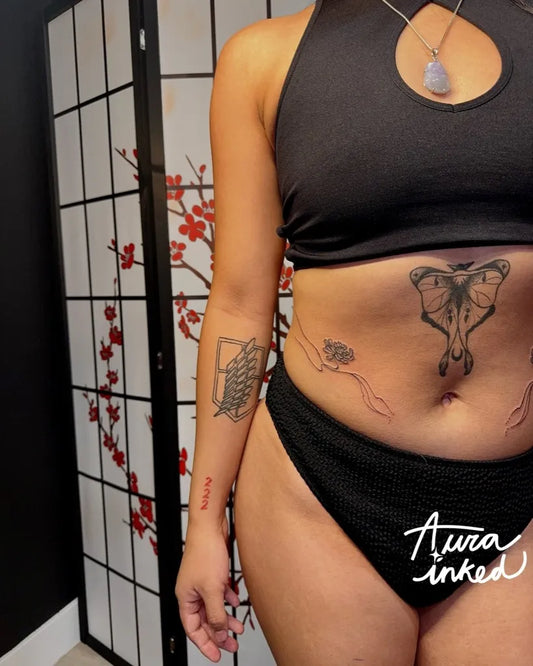 Medium Blackwork Moth and Wings Tattoo on Women Stomach by @aurainked