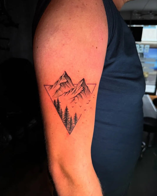 Medium Blackwork Mountain Tree Bird Tattoo on Men Arm by @regal.ink.studio