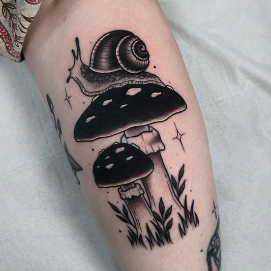 Medium Blackwork Mushroom Snail on Women Leg Tattoo by @katiemaytattoos