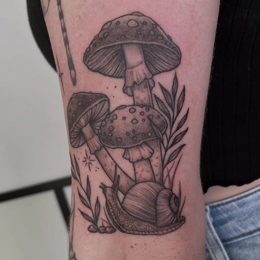 Medium Blackwork Mushrooms and Snail on Women Arm Tattoo by @maddiebowietattoos