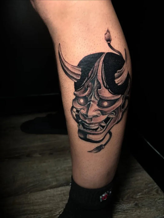Medium Blackwork Oni Mask on Men Leg Tattoo by @marianoo_tattoo