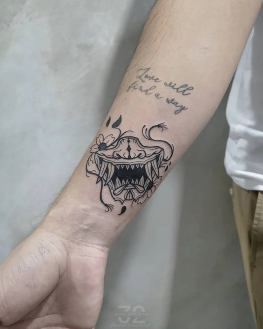 Medium Blackwork Oni Mask with Flowers and Text on Men Arm Tattoo by @marcucho32