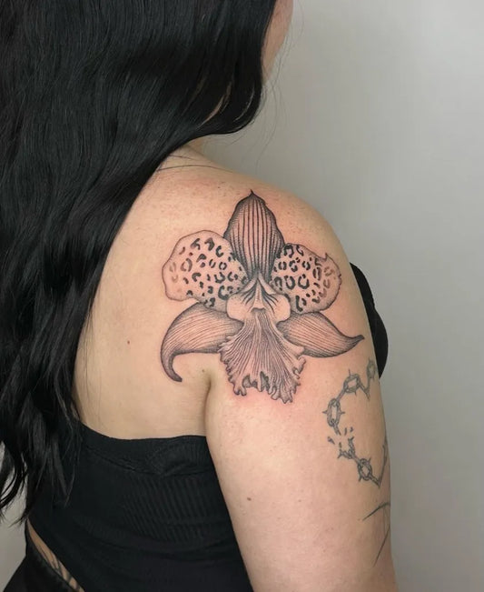 Medium Blackwork Orchid Tattoo on Women Shoulder by @kingkydrawers