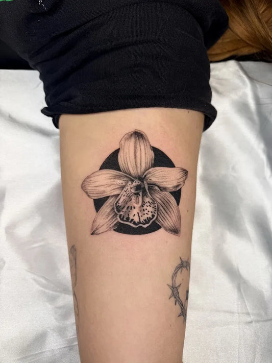 Medium Blackwork Orchid Tattoo on Women Thigh by @oliviadawntattoos