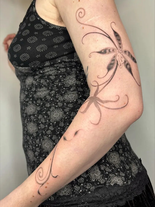 Medium Blackwork Orchid Vine Tattoo on Women Arm by @eclipsia.ink