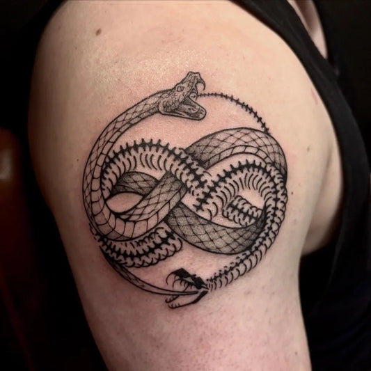 Medium Blackwork Ouroboros Tattoo on Men Shoulder by @cryptogeist