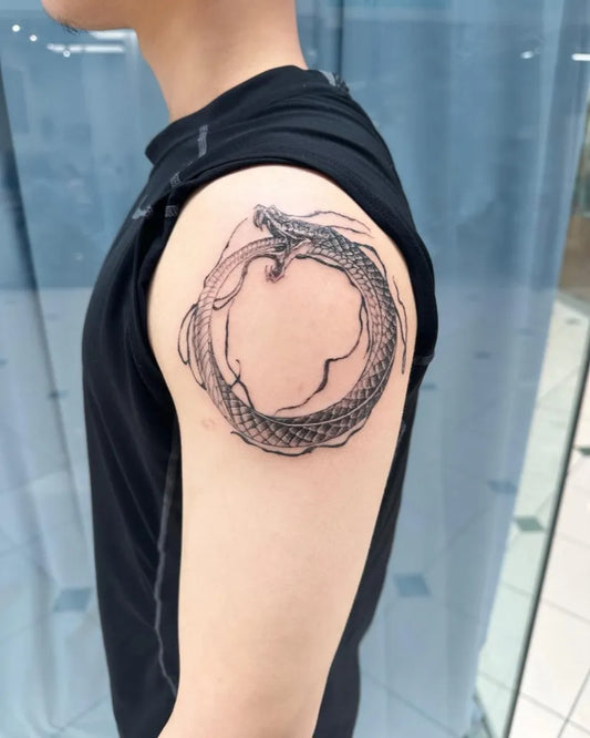 Medium Blackwork Ouroboros Tattoo on Men Shoulder by @tat2bymarlonm