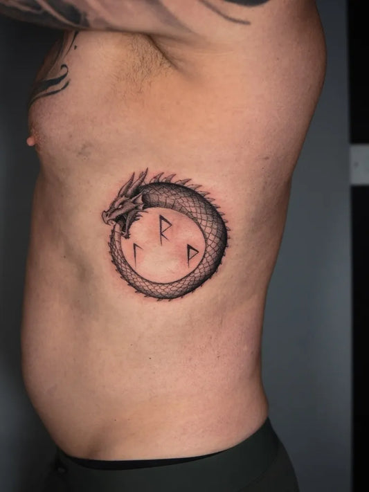 Medium Blackwork Ouroboros Tattoo on Men Torso by @steffan_eagle_tattooer