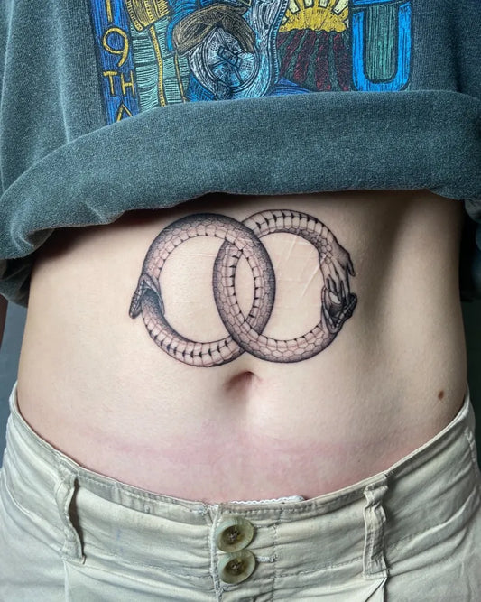 Medium Blackwork Ouroboros Tattoo on Women Abdomen by @synchromystic.tattoo