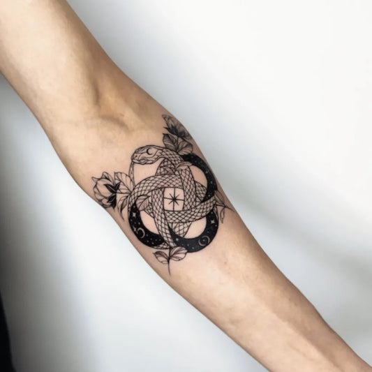 Medium Blackwork Ouroboros Tattoo on Women Arm by @mantletattoo