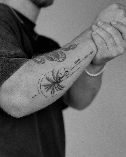 Medium Blackwork Palm Tree Arrow Snake Tattoo on Men Arm by @cb_studi0