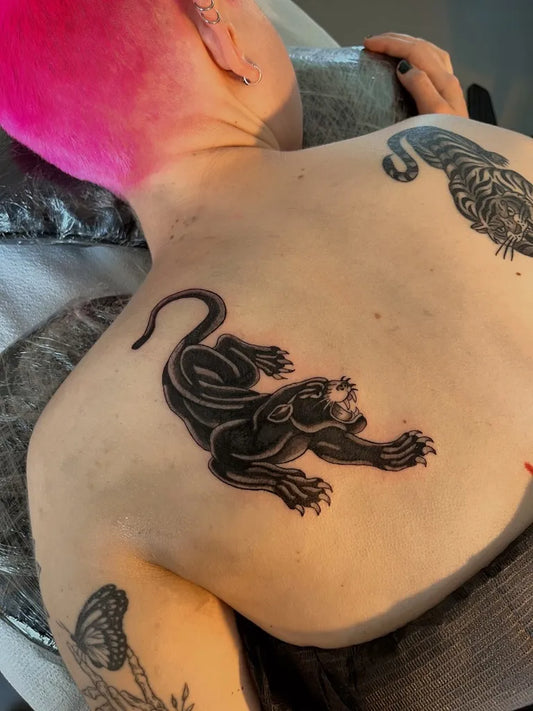 Medium Blackwork Panther Tattoo on Women Back by @thankyouhappytattoo