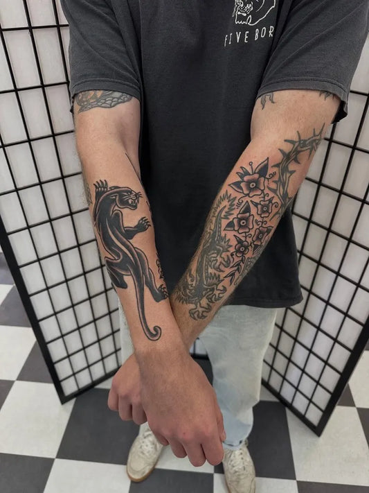 Medium Blackwork Panther and Geometric Floral Tattoo on Men Arm by @jackxtattoo