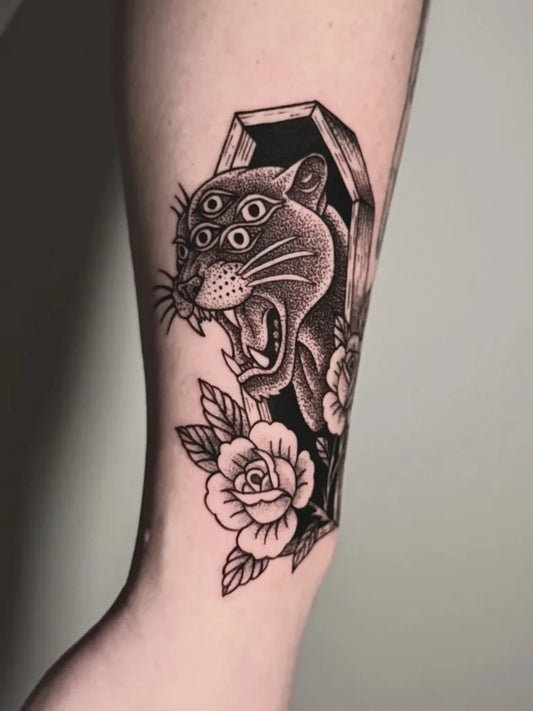 Medium Blackwork Panther in Coffin with Rose Tattoo on Women Arm by @che.hojas.ink