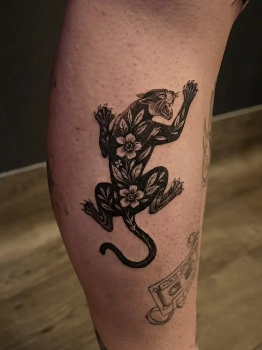 Medium Blackwork Panther with Flowers Tattoo on Women Thigh by @rudrainktattoo