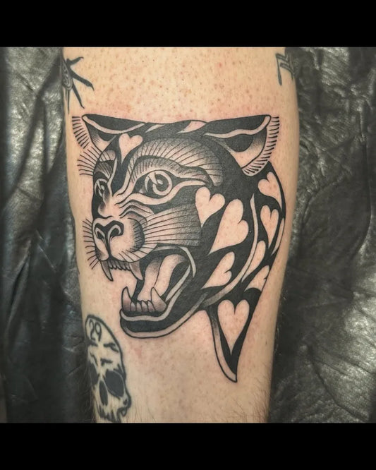 Medium Blackwork Panther with Hearts Tattoo on Women Arm by @liv.laeta.tattoo
