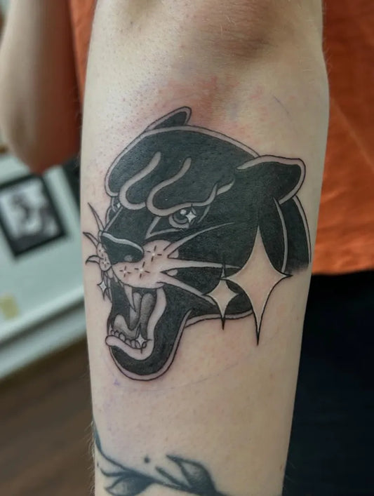Medium Blackwork Panther with Stars Tattoo on Women Arm by @cranberrytattoos