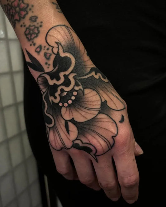 Medium Blackwork Peony Flower on Women Wrist Tattoo by @rusty.needles