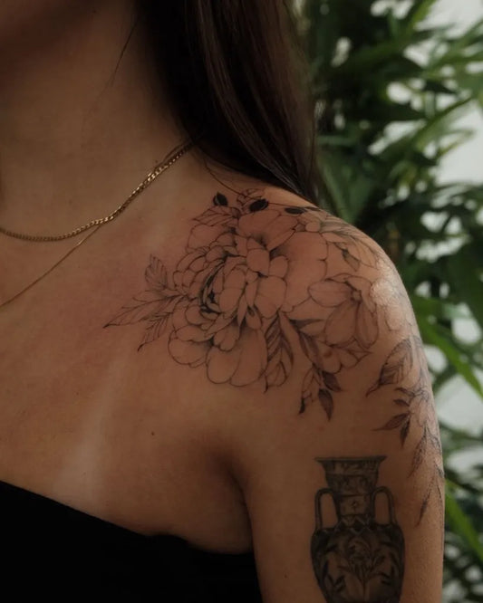 Medium Blackwork Peony Vase Tattoo on Women Shoulder by @lovemore.tattoo