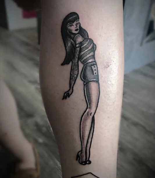 Medium Blackwork Pin Up Girl Tattoo on Women Thigh by @garethbennett_tattooist