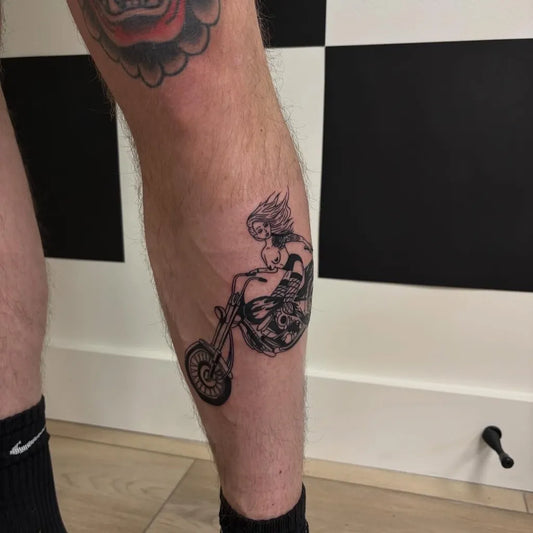 Medium Blackwork Pin Up Girl on Motorcycle Tattoo on Men Leg by @inkbyregs