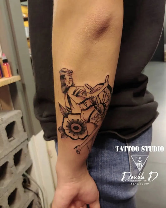 Medium Blackwork Pin Up Girl with Ship Wheel and Flowers Tattoo on Women Arm by @hyenansol