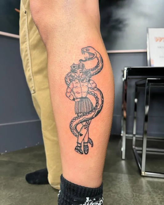 Medium Blackwork Pin Up Girl with Snake Tattoo on Men Leg by @lewis9ines